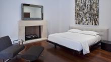 Master bedroom with FIAM Caadre mirror above fireplace.