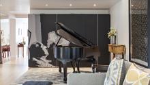 Grand piano in front of Valcucine cabinets using sliding glass doors.