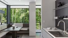 Wet bar with breakfast nook looking out into forest view.