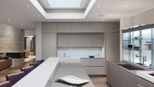 View of kitchen looking towards towers with upper cabinets.