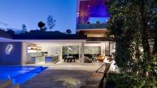 Living areas and Valcucine Artematica kitchen at dusk.