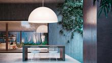 FontanaArte: Avico suspension lamp in outdoor setting above table.