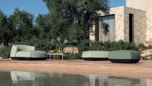 Kristalia: Brioni Outdoor collection of poufs, lounge armchairs and daybeds adjacent to water.