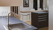 Ranch Acres: Valcucine Artematica vitrum kitchen detail of wetbar with cantilevered breakfast bar in background.