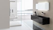 Toscoquattro: Stone wall-hung washbasin in the Time collection paired with a Concerto shower. 