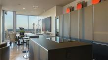 Valcucine Artematica kitchen in island configuration using glass and wood finishes.