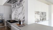 Range with marble backsplash and marble wrapped wet bar niche utilizing zip water system 