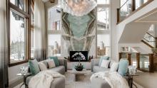 Living room surrounded by snow covered mountain landscape.