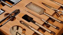 Kitchen drawer with specific placement of kitchen utensils, carved out of walnut.