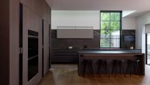 A mix of warm wood tones, glass, and grey antalya marble make this a one of a kind kitchen.